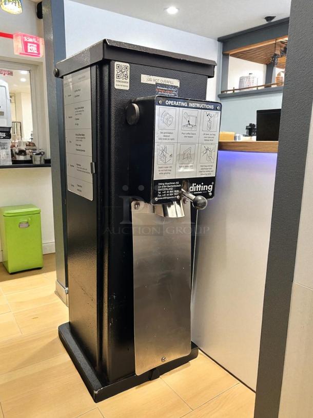 Ditting KR1203 commercial espresso coffee grinder in like-new condition, features metal exterior, visible operating instructions.