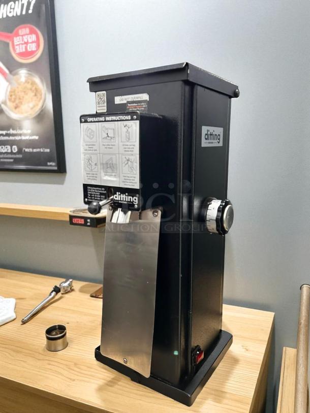 Ditting KR1203 commercial espresso coffee grinder, like new condition, black with silver accents, visible operating instructions.