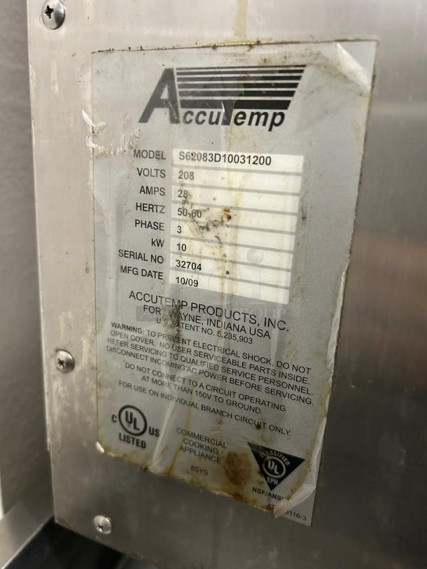 AccuTemp S62083D100 steamer label showing model, volts, amps, hertz, phase, kW, serial number, and manufacture date.