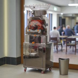 Citrocasa 8000 SB-ATS Advance citrus juicer, stainless steel, "As Is" condition, with visible juicing mechanism and storage cabinet.