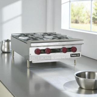 Brand new Therma-Tek TCHP24-4 countertop gas hotplate with 4 burners and red control knobs. Tested and working.