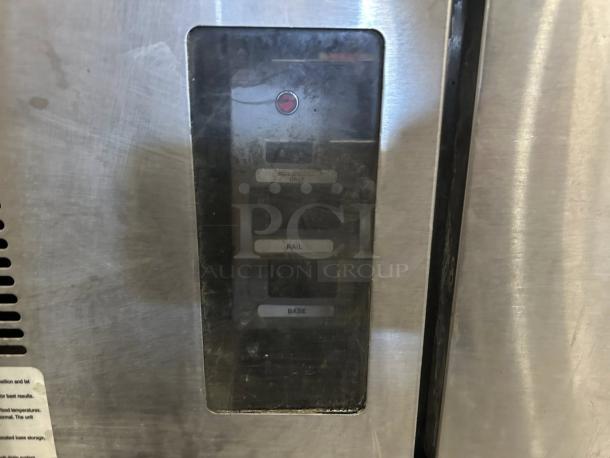 Stainless steel appliance with control panel, featuring buttons labeled "Well-only," "Rail," and "Base." Visible wear on surface.