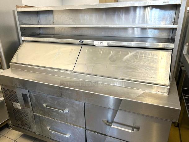 Stainless steel refrigerated prep table with two drawers and open shelf, showing minor surface wear, model 193.