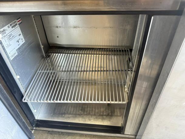 True TWT-72-HC worktop refrigerator interior showing a clean metal shelf. Visible model label indicates 115v power usage.