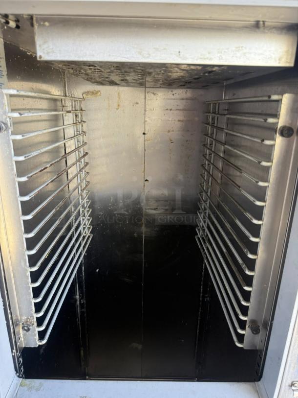 Great condition McCall MDL 1-102001 single door reach-in refrigerator interior, showing clean metal racks.