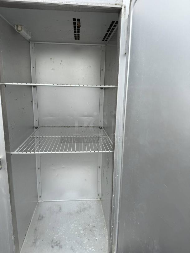 Traulsen G10010 reach-in refrigerator, 23.43 cu ft, excellent condition, one-section solid door, shelves visible.