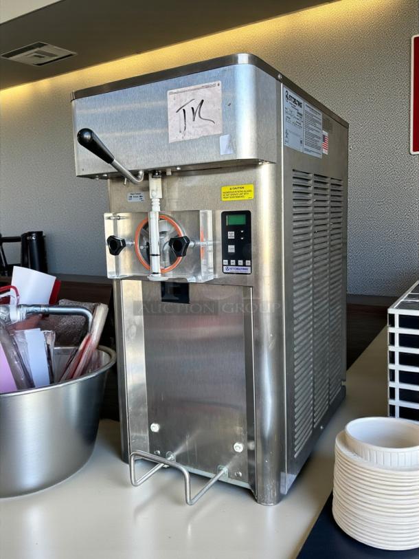 Stoelting F111 soft serve machine in excellent condition, stainless steel, tested and working, with digital controls and caution labels.