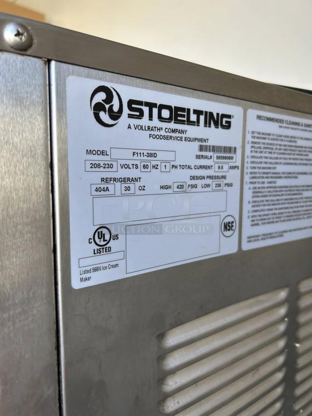 Stoelting F111 soft serve machine in excellent condition. Label shows model, voltage, and certifications. Tested and working.