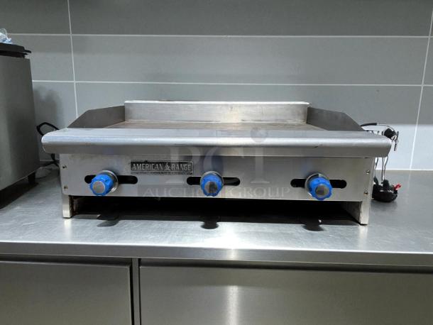Imperial ITG-36 36" commercial gas griddle with thermostatic controls, tested and working, stainless steel surface, blue knobs.