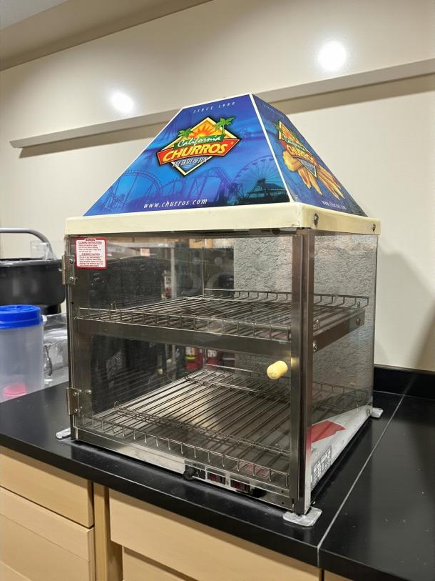 Wisco 680-1 Food Warming Merchandiser, black cabinet, single door, 2 shelves, excellent condition, vibrant branding on top.