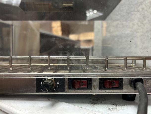 Wisco 680-1 food warming merchandiser, black cabinet, single door, 2 shelves. Excellent condition, adjustable temperature dial.