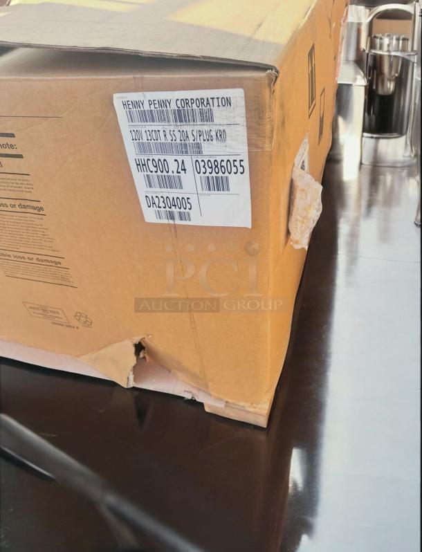 Factory New Henny Penny HHC900.24 Mobile Heated Holding Cabinet in box; 120V, 15-pan capacity, ready for use.