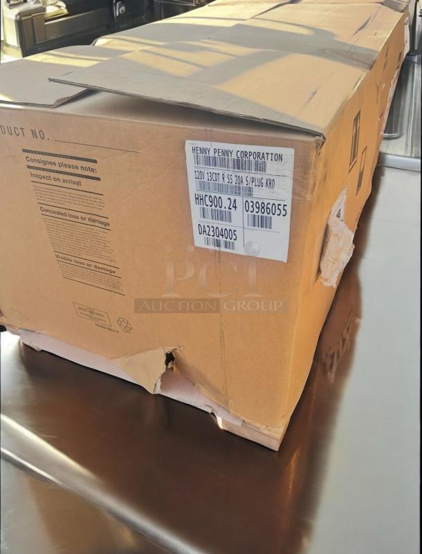 Factory new Henny Penny HHC900.24 insulated mobile heated holding cabinet, boxed, model label visible, ready for use.