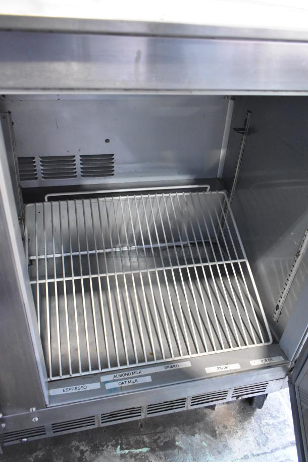 Beverage Air UCR48A stainless steel undercounter cooler, two doors, commercial casters, shelving, visible labels, 115V.