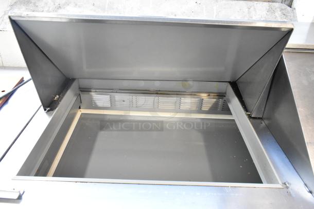 Beverage Air SPE60-24M stainless steel commercial prep table with open bain marie section, on casters. Professional condition.