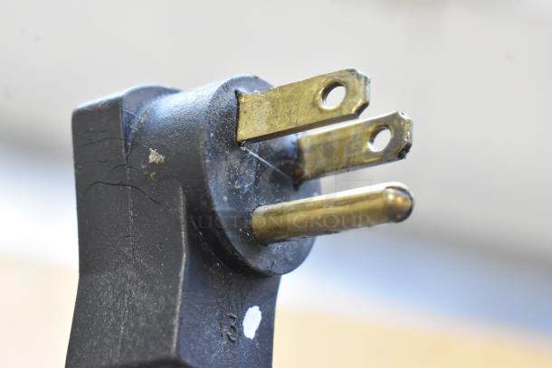 Close-up of a three-prong electrical plug for a Beverage Air SPE60-24M sandwich prep table, showing prongs detail.