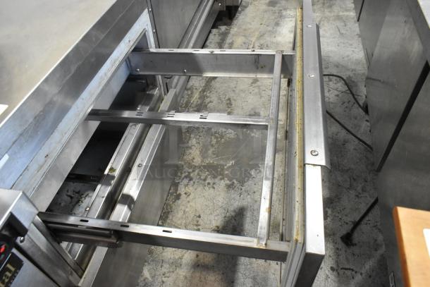 Stainless steel 2-drawer undercounter cooler, 115 volts, 1 phase, open drawer showing interior, in used condition.