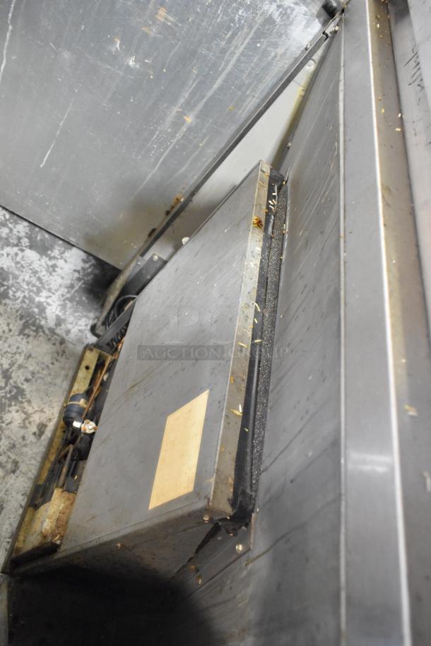 Stainless steel 2-drawer undercounter cooler, showing wear and dirt. 115 volts, 1 phase. Suitable for commercial use.