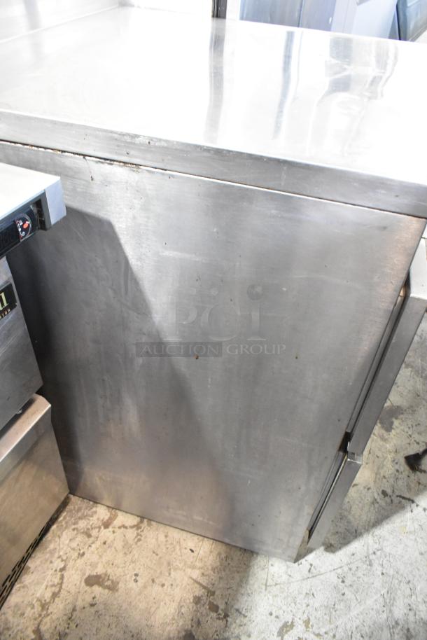 Stainless steel 2-drawer undercounter cooler, 115 volts, 1 phase, features visible wear.