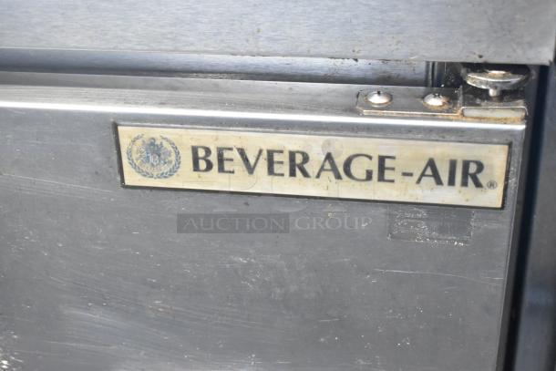 Beverage Air stainless steel 2-door undercounter cooler on casters, 115 volts, 1 phase. Logo plaque visible, slightly worn.