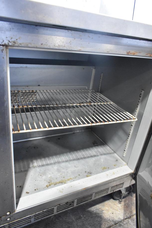 Beverage Air stainless steel 2-door undercounter cooler on casters, showing interior shelves. Used condition. 115V, 1 Phase.