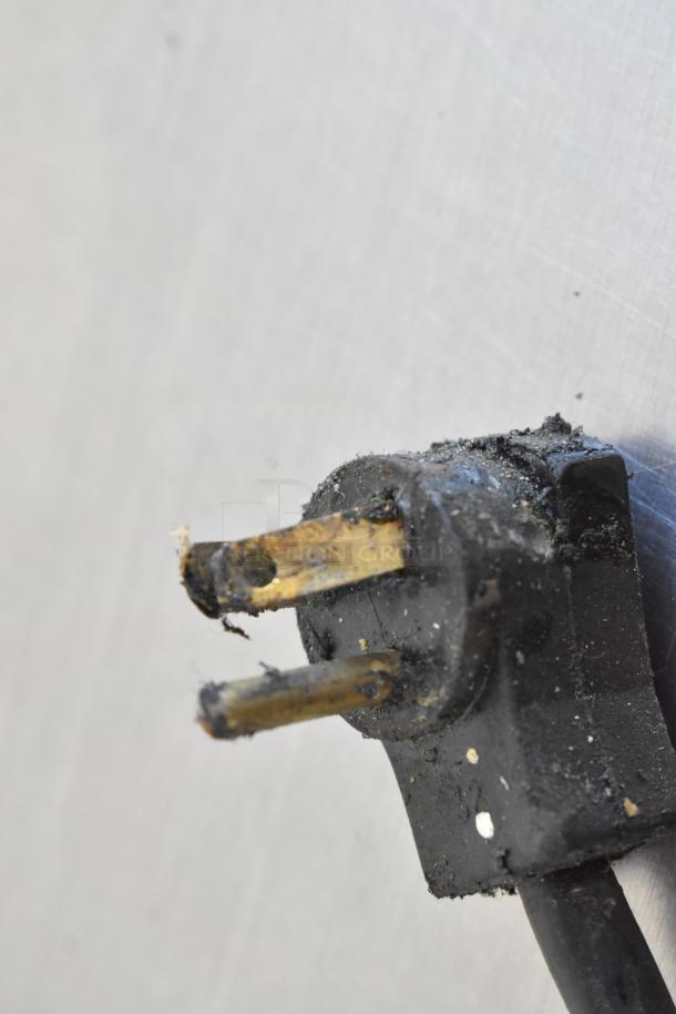 Close-up of a damaged two-prong plug from a Beverage Air Stainless Steel Commercial 2 Door Undercounter Cooler.