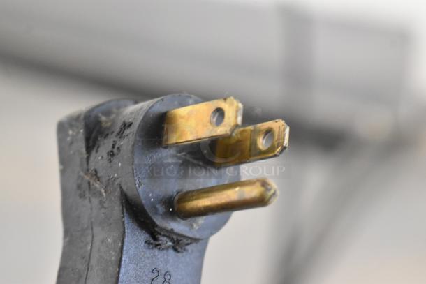Close-up of a three-prong plug for a Beverage Air WTR60A commercial cooler, indicating electrical connection details.