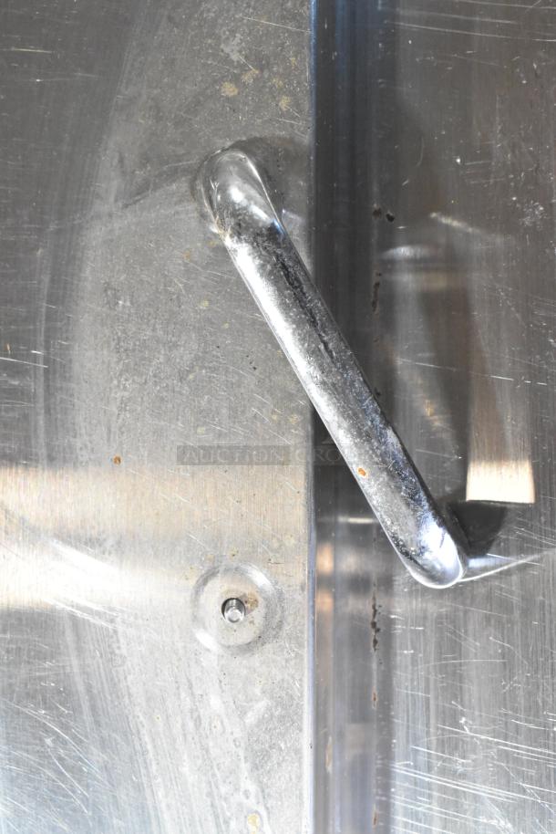 Close-up of handle on 2019 Continental SW48-18M stainless steel prep table. Visible wear on metal.