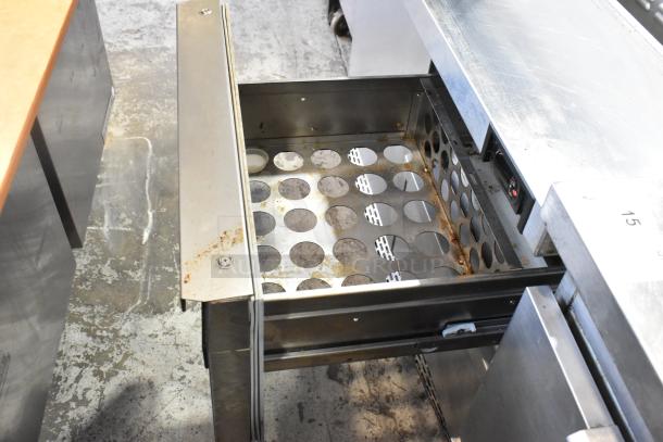 2019 Continental SW48-18M stainless steel prep table with open drawer, showing storage slots and some rust.
