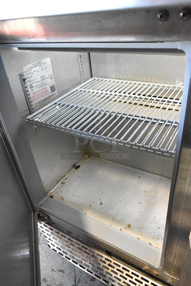 2019 Continental SW48-18M stainless steel sandwich prep table interior, showing shelves and wear. Label indicates model details.