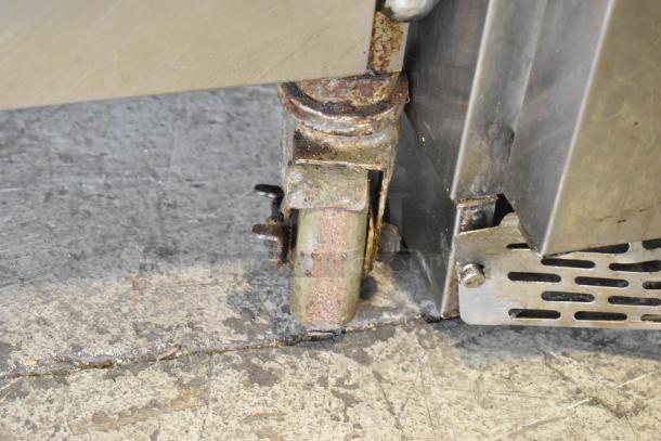 Alto Shaam 750-S stainless steel heated holding cabinet on worn commercial caster. Visible rust and wear marks. 120V, 1 phase.