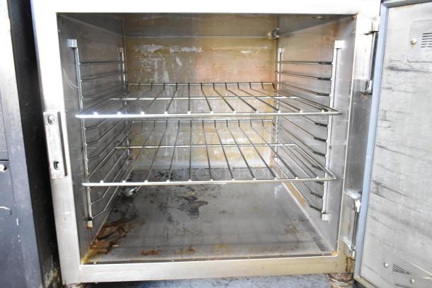 Alto Shaam 750-S stainless steel heated holding cabinet, 120 volts, commercial casters, with visible wear on interior.