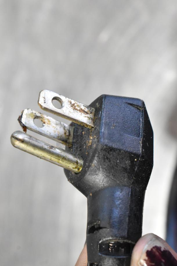 Close-up of a 120-volt plug for an Alto Shaam 750-S heated holding cabinet, showing some wear and rust.