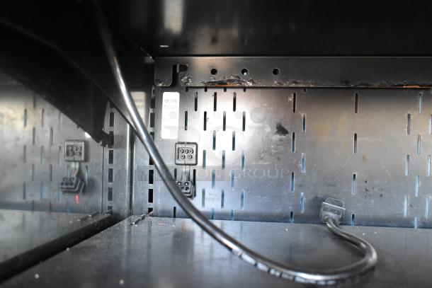 Structural Concepts Oasis B32EW Reach In Merchandiser interior, metal surface with visible electrical components, 120V, 1 Phase.
