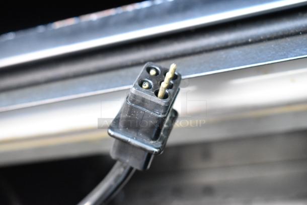 Structural Concepts Oasis B32EW plug detail, commercial reach-in merchandiser. 120V, 1 phase. Black plug shown close-up.