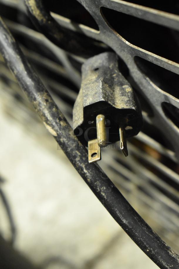 Close-up of a worn electrical plug for the Structural Concepts Oasis B32EW Merchandiser, 120V, 1 Phase.