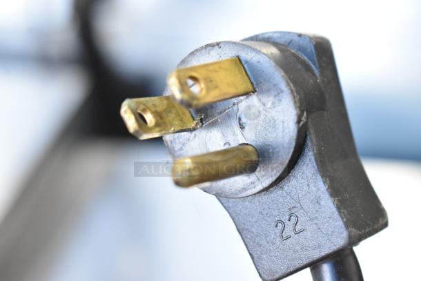 N/A - Image shows a close-up of a power plug, not the Beverage Air UCR48A cooler.