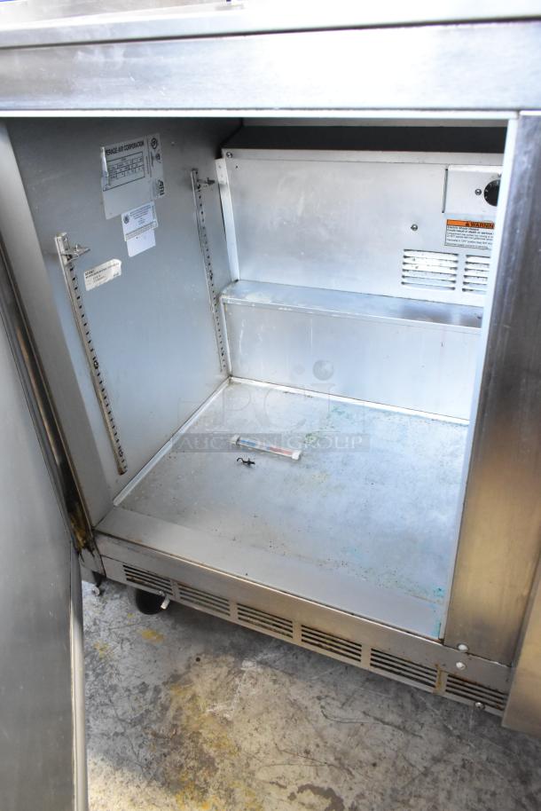 Beverage Air UCR48A stainless steel 2-door undercounter cooler, on commercial casters. 115 volts, 1 phase. Visible interior and labels.