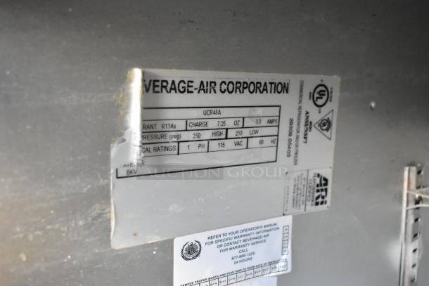 Beverage Air UCR48A stainless steel cooler, 2 doors, on casters. Features voltage, refrigerant, and safety labels.
