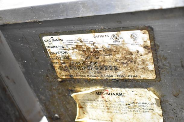 Alto Shaam 750-S holding cabinet label, showing volts: 120, model: 750-S, UL listed. Stainless steel exterior visible.