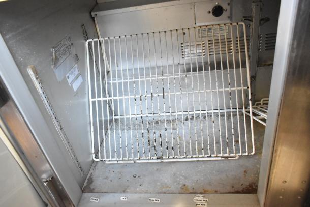 Beverage Air UCR48A stainless steel 2-door cooler interior with wire rack, visible labels, and signs of wear. 115V, 1 phase.