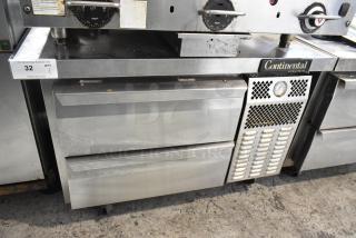 Continental stainless steel 2-drawer chef base on commercial casters, 115 volts, 1 phase, visible wear.
