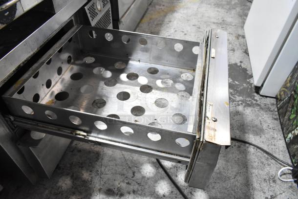 Continental stainless steel commercial 2-drawer chef base on casters, showing open perforated drawer. 115V, 1 phase.