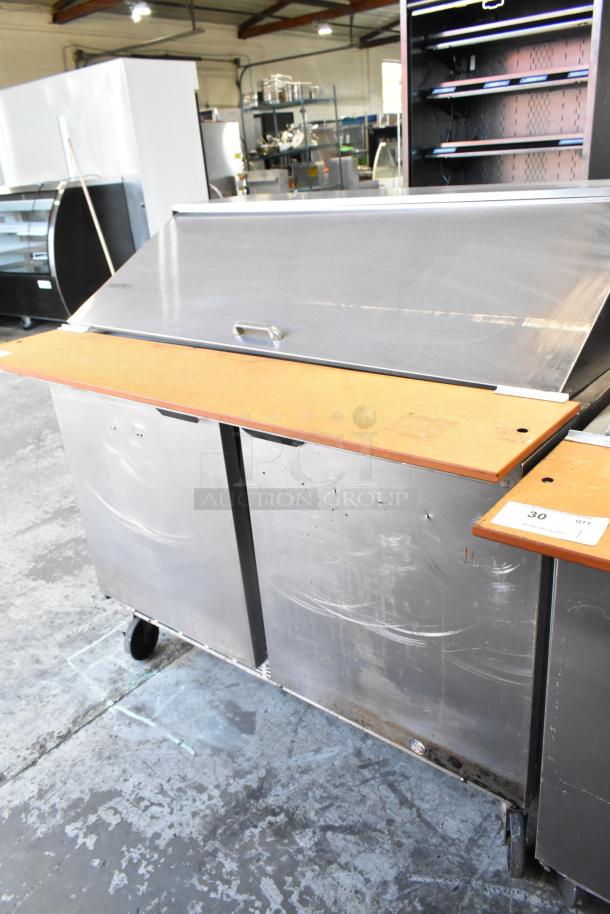 Beverage Air SPE48-18M stainless steel sandwich prep table with commercial casters, 115V, shows signs of wear.