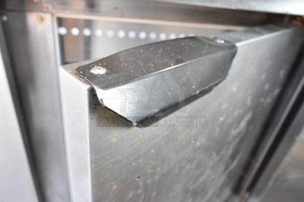 Beverage Air SPE48-18M prep table corner showing stainless steel surface and handle detail, indicating wear.