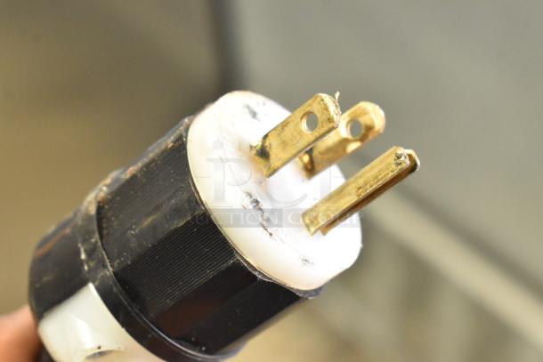 Electric plug detail of Beverage Air SPE48-18M prep table, showing a three-prong connector with visible wear.