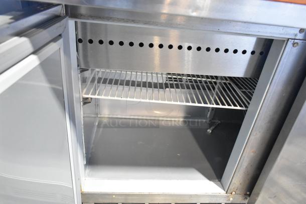 Beverage Air SPE48-18M stainless steel sandwich salad prep table, clean, on casters, visible shelf inside, 115V, 1 phase.