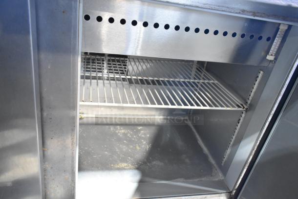 Beverage Air SPE48-18M stainless steel prep table with shelf and casters, 115V, good condition, interior view.