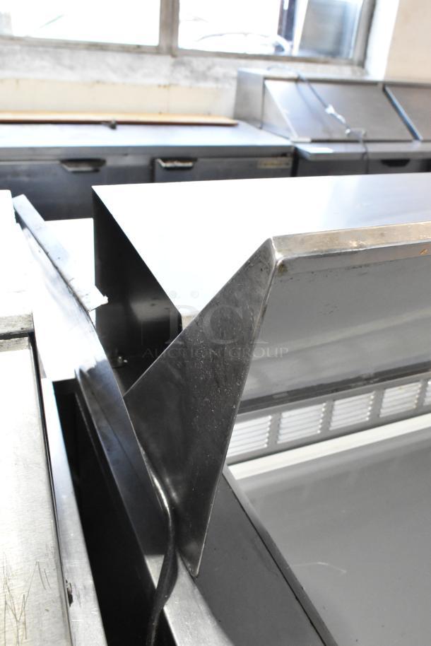 Beverage Air SPE48-18M stainless steel prep table in good condition, showing commercial setup and casters, 115V, 1 Phase.
