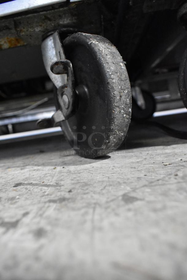 Beverage Air SPE48-18M commercial prep table caster wheel, showing worn condition. Perfect for mobility enhancement.